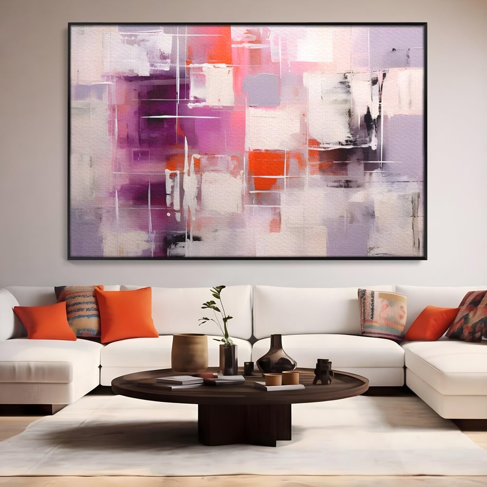 Tablou canvas cu pictura abstracta cu pete mov, in rama de aluminiu negru, pe perete intr-un living